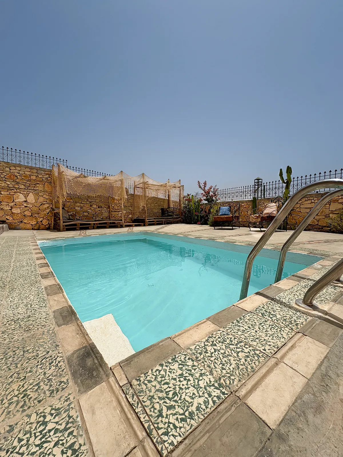 Guests relaxing by the ocean-view pool at Taghazout Surf Villa during an all-inclusive Moroccan surf week.