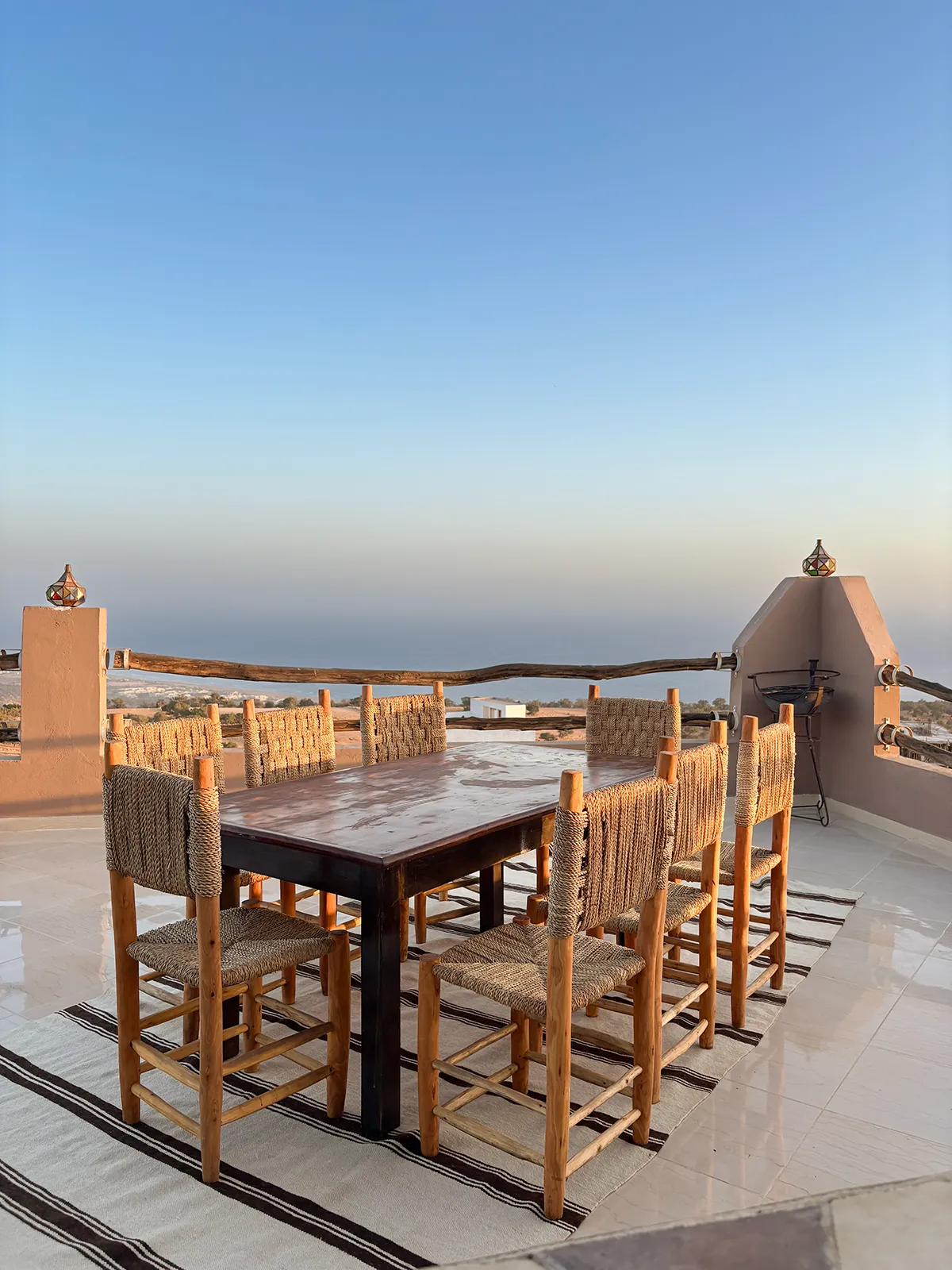 Rooftop dining area at Taghazout Surf Villa with panoramic sea views included in all-inclusive surf week.