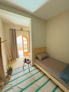 Private room at Taghazout Surf Villa with sea view and direct pool access for all-inclusive Moroccan surf stay